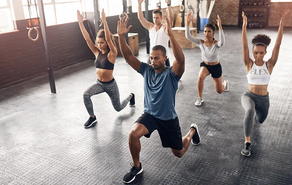 Group fitness class doing functional training exercises